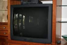 This is a picture of an older tube television displayed in a living room setting